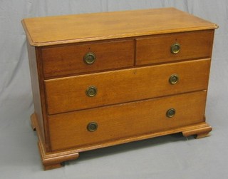 An Art Nouveau honey oak chest of 2 short and 2 long drawers with canted corners, raised on ogee bracket feet 45"