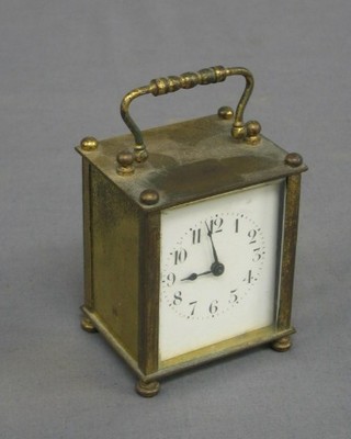A 19th/20th Century French 8 day carriage clock with enamelled dial and Arabic numerals contained in a gilt metal case
