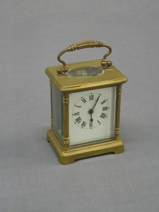 A French 19th Century 8 day carriage clock with enamelled dial and Roman numerals, contained in a gilt metal case (chip to glass)
