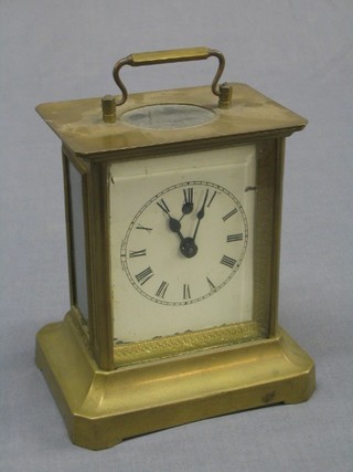A 19th/20th Century Continental musical carriage alarm clock, contained in a gilt metal case and playing "She Was One of the Early Birds and I Was of the Worms"