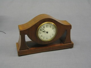 An Edwardian French 8 day bedroom time piece with enamelled dial and Arabic numerals contained in a brass inlaid mahogany shaped case