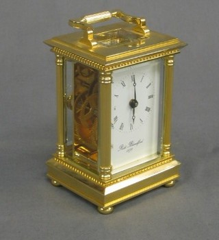 A reproduction 19th Century carriage clock with porcelain dial and Roman numerals, the dial marked Robert Blanford, contained in a gilt metal case