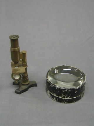 A 19th/20th Century brass single pillar microscope together with  large circular lens, 4" (2)