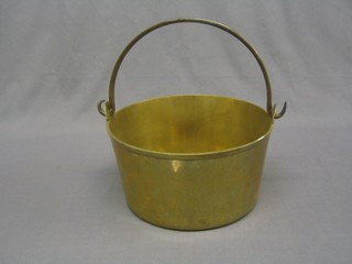 A brass preserving pan with polished steel handle