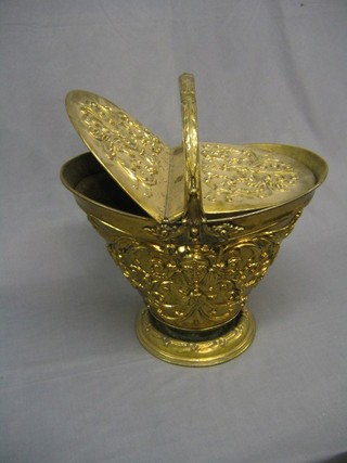 A Victorian embossed brass helmet shaped coal box