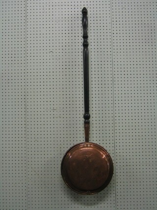 A 19th Century copper warming pan with turned fruitwood handle