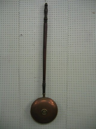 A 19th Century engraved copper warming pan with turned ebony handle
