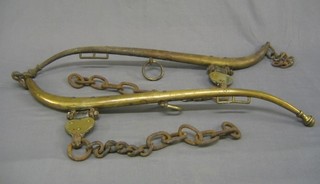 A pair of 19th Century brass horse hanes with acorn finials
