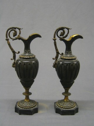 A pair of 19th Century carved bronze and gilt ormolu mounted ewers raised on stepped bases 10" (slight chips to bases)