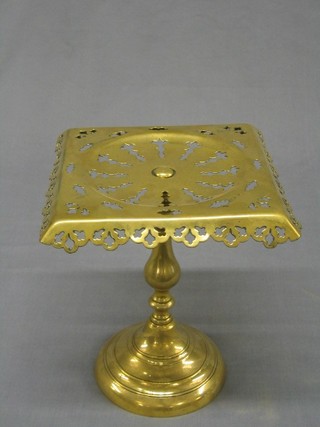 A Victorian pierced brass teapot stand raised on a circular spreading foot 8"