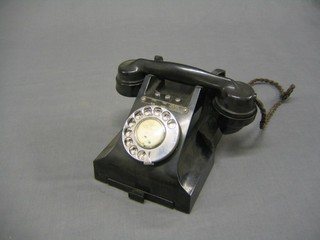 An old black dial telephone with 3 buttons, four wire, two wire, two wire bat fed to line