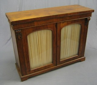 A Victorian walnut chiffonier, the interior fitted shelves enclosed by a arched panelled doors and with Vitruvian scrolls to the sides, raised on platform feet, 48"
