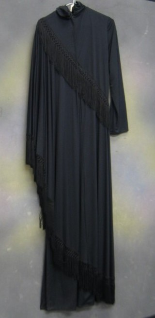 A John Charles poncho style black long sleeved evening dress with tassel decoration, size 16