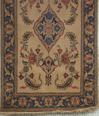 An old white ground Persian rug with central medallion with blue and floral borders and with signature to base, 55" x 32"