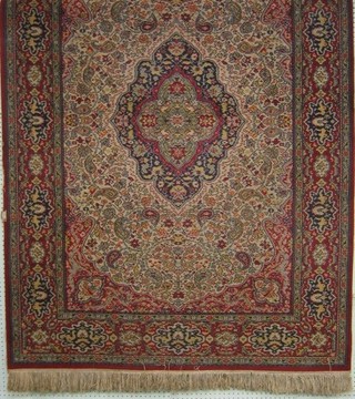 An Axeminster red ground Persian style rug, with medallion to the centre within multi-row borders 81" x 55"