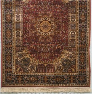 A contemporary machine made Madras rose ground Persian pattern rug 68" x 49"