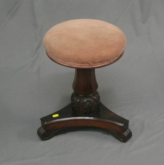 A William IV carved rosewood adjustable piano stool, raised on a bulbous turned and triform base (triform base with old break)
