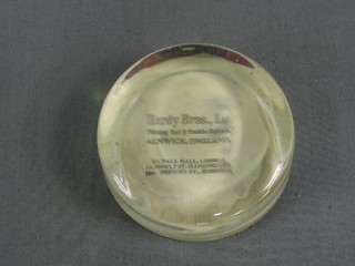 A circular Hardy's Bros glass paperweight