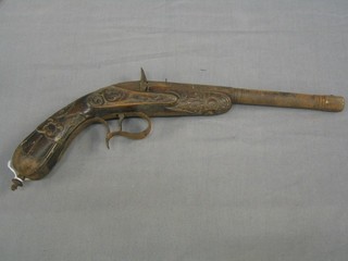 An 18th/19th Century Italian/Spanish? pin fire pistol, with heavily carved grip throughout, having a 9" octagonal and rounded barrel