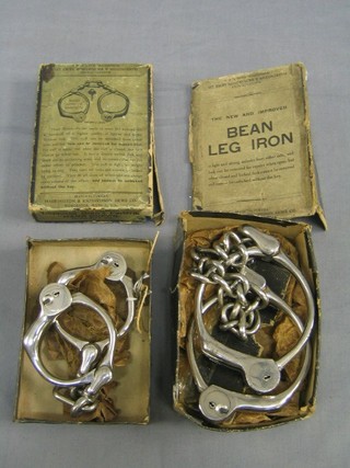 A pair of Improved Beans handcuffs together with a pair of Beans leg irons, both boxed and with 1 key