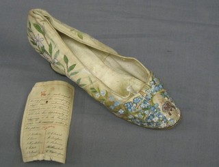 An interesting 18th/19th Century lady's silk slipper with floral and armorial decoration, together with a handwritten slip of paper "We the undersigned having found the accompanying slipper under extraordinary circumstances on the 1 February 1888, take this opportunity of returning it to its lawful owner with sincerest wishes for her future"