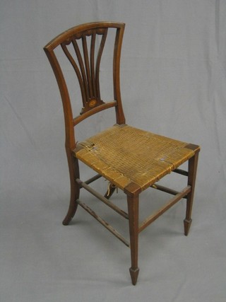 An Edwardian mahogany fan shaped splat back bedroom chair with woven rush seat