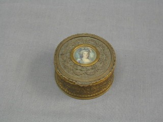 A 19th Century embossed circular gilt metal trinket box, the lid set a portrait miniature on ivory of a lady 3" (hinge f)