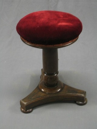 A Victorian rosewood adjustable piano stool raised on a column with triform base