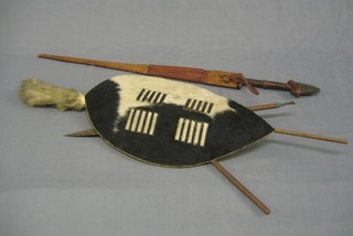 An Eastern double edged dagger and a miniature Zulu spear and shield