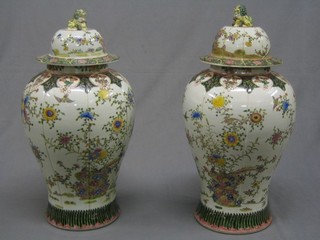 A large pair of reproduction 19th Century Canton famille vert porcelain urns and covers 24"