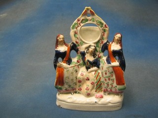 A 19th Century flat back Staffordshire watch stand supported by 3 ladies (f and r and chip to the base) 11"