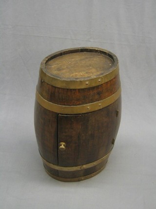An oval coopered barrel converted for use a drinks cabinet fitted 2 glass spirit decanters 15"
