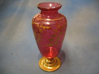 A 19th/20th Century red baluster vase raised on a gilt metal foot (foot f) 11"