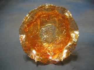 An orange Carnival glass circular dish with rose decoration 8"