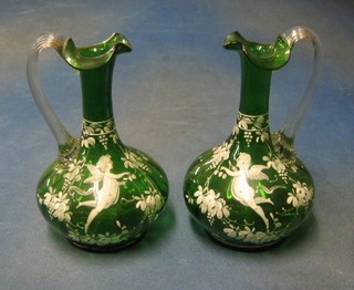 A pair of Mary Gregory style green glass ewers with clear glass handles decorated cherubs, base marked 167, 8"