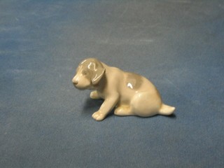 A Royal Copenhagen figure of a seated puppy, the base marked 1311, 4"
