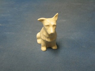 A Beleek figure of a seated dog, the base with green Beleek mark, slight chip 4"
