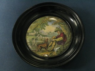 A 19th Century Prattware pot lid contained in an oak socle frame, shepherd and dog (star crack to back)