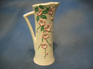 A Malingware (second?) waisted pottery jug with floral decoration, 11"