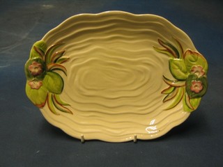 A Clarice Cliff leaf shaped twin handled dish, the base marked Clarice Cliff Newport Pottery England and impressed 982, 11"