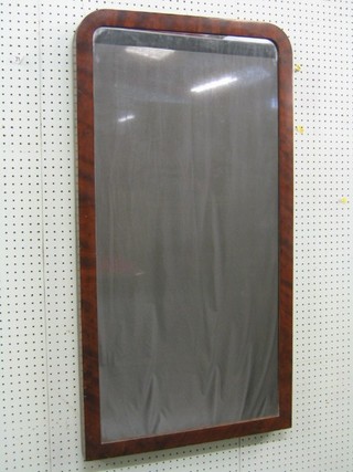 An arched plate mirror contained in a mahogany frame 43"