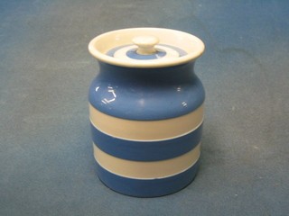 A circular T G Green blue and white striped Cornish kitchenware storage jar and cover, the base with black shield mark 5"
