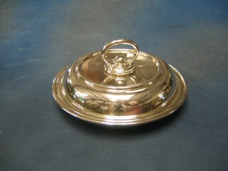 A circular silver plated entree dish and cover