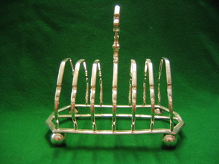 A silver plated 7 bar toast rack raised on bun feet