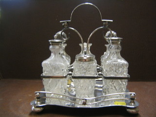 A  rectangular silver plated cruet frame with 6 cut glass bottles (1 f)