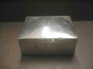 A silver cigarette box with hinged lid  Birmingham 1919, monogrammed to the lid (marks rubbed, some dents) 7"