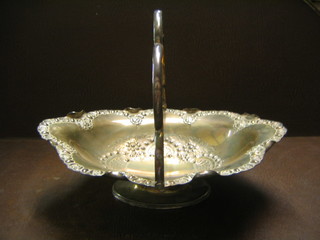 An oval embossed silver plated cake basket with swing handle
