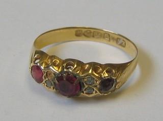A lady's 18ct gold dress ring inset 3 red stones and 3 diamonds