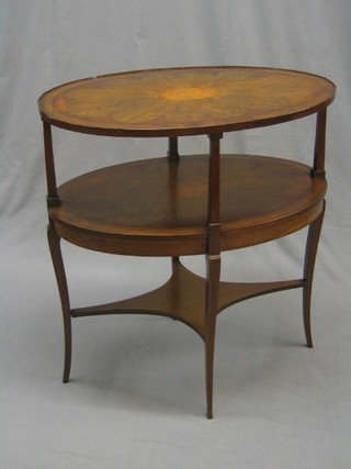 An Edwardian oval inlaid mahogany 2 tier etagere with satinwood stringing, raised on splayed feet 29"