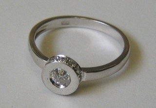 A lady's 18ct gold dress ring set a solitaire diamond (totally enclosed)